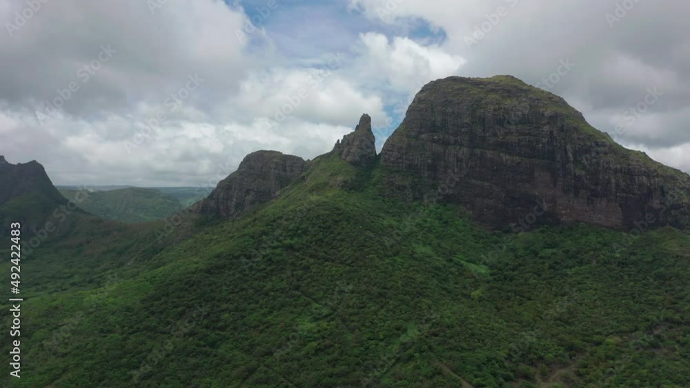 Shooting from top to bottom the peaks of mountains and jungles of Mauritius, the sky in clouds. Flight over the peak of the mountain Shooting from top to bottom the peaks of mountains and jungles of Mauritius, the sky in clouds. Flight over the peak of the mountain