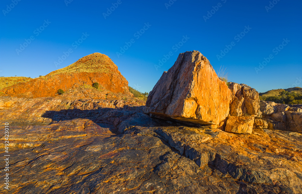 Sunset over a colorful landscape with rocks and layers of Jasper in the vicinity of the village of Marble Bar, Western Australia
