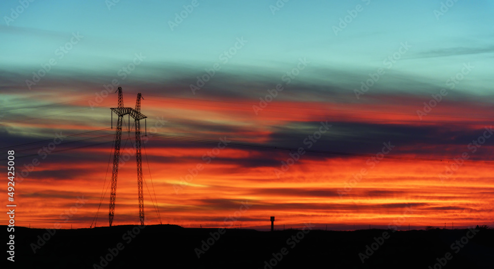 High-voltage towers against the backdrop of the sunset near the city of Rostov on Don.