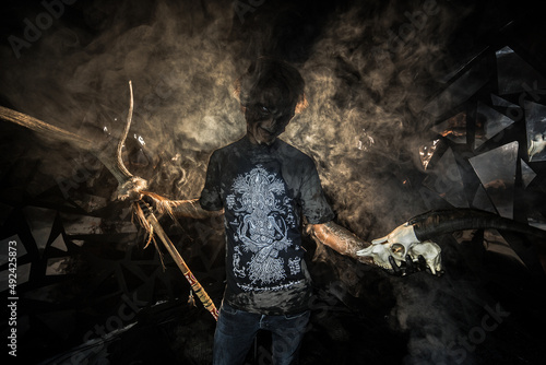 scary sorcerer in smoke. voodoo rite