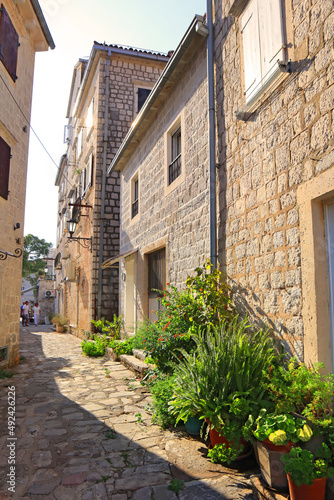 Fototapeta Naklejka Na Ścianę i Meble -  Street with old historical buildings in sunny day in Perast, Montenegro