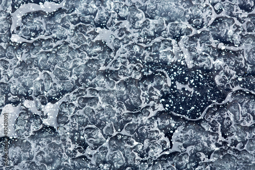Melting snow abstract background with gray tint.