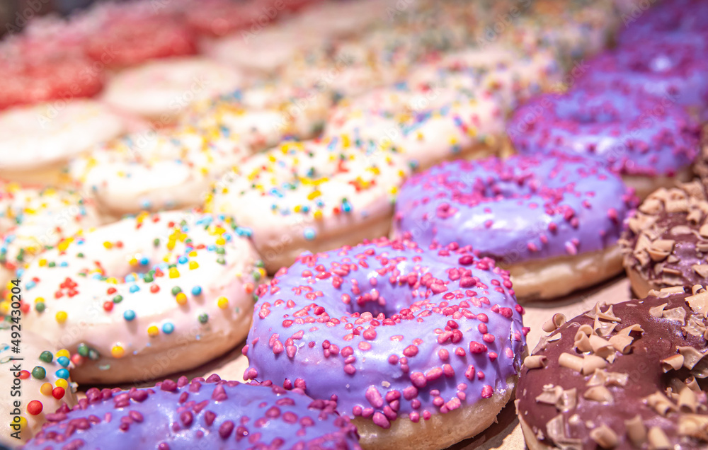 Close up of different donuts with sugar, frosted, glaze, and sprinkles. Close up of different donuts with sugar, frosted, glaze, and sprinkles.