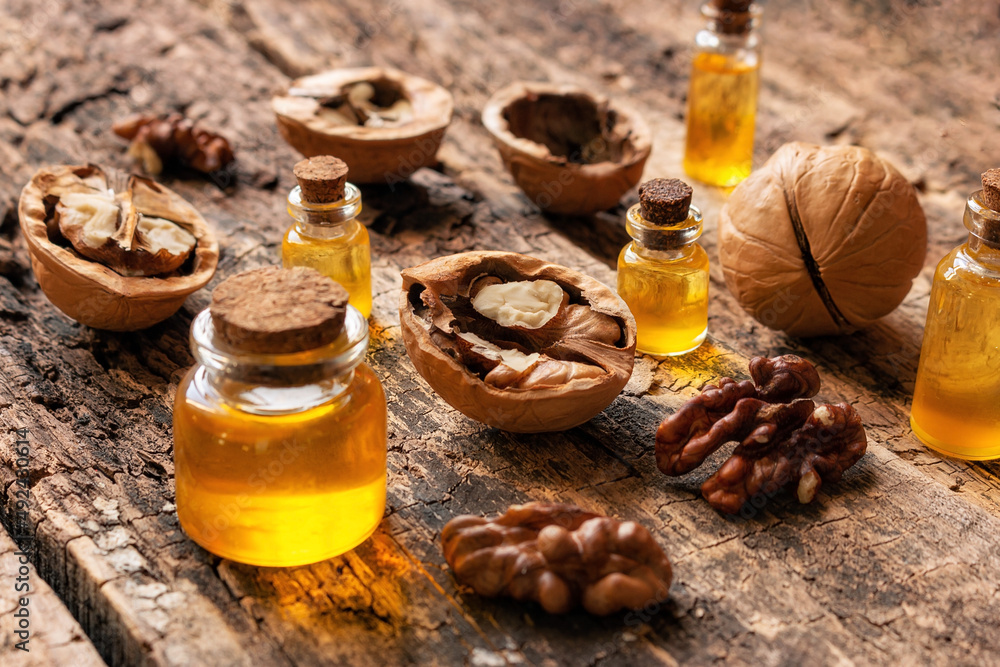 natural cosmetics and medicine from walnut oil on a wooden background natural cosmetics and medicine from walnut oil on a wooden background