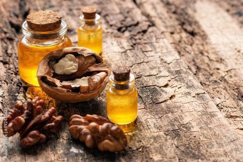 walnut oil on wooden background with space for text closeup