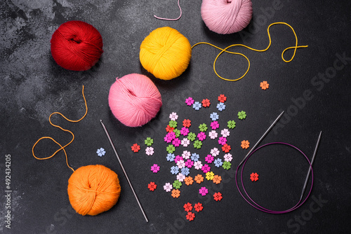 Colorful balls of wool on concrete table. Variety of yarn balls