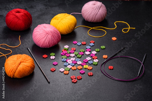 Colorful balls of wool on concrete table. Variety of yarn balls