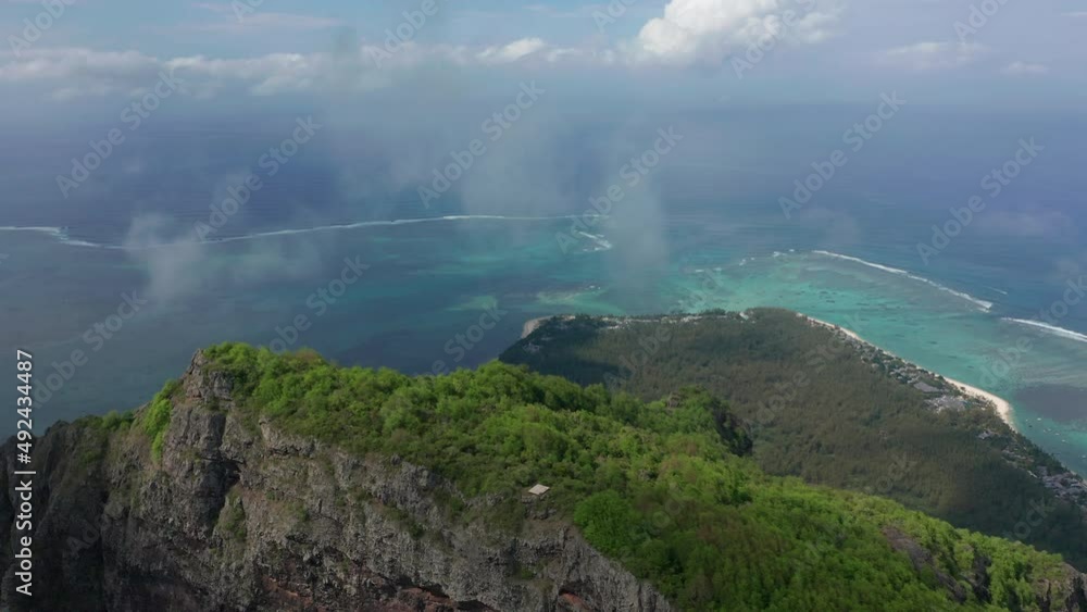 Flight over the peak of the mountain. Le Morne Brabant mountain in Mauritius. Exotic island with beautiful lagoon Flight over the peak of the mountain. Le Morne Brabant mountain in Mauritius. Exotic island with beautiful lagoon