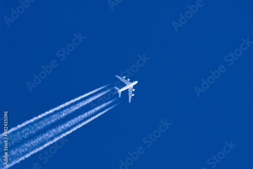Trail from the plane in the blue sky. © aapsky