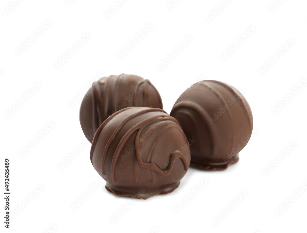 Fototapeta premium Delicious sweet chocolate truffles on white background