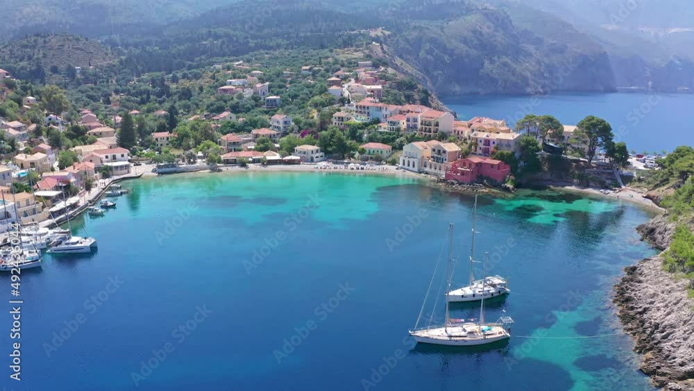 Ionian sea resort town Assos. Beautiful bay with boats and greek houses Ionian sea resort town Assos. Beautiful bay with boats and greek houses