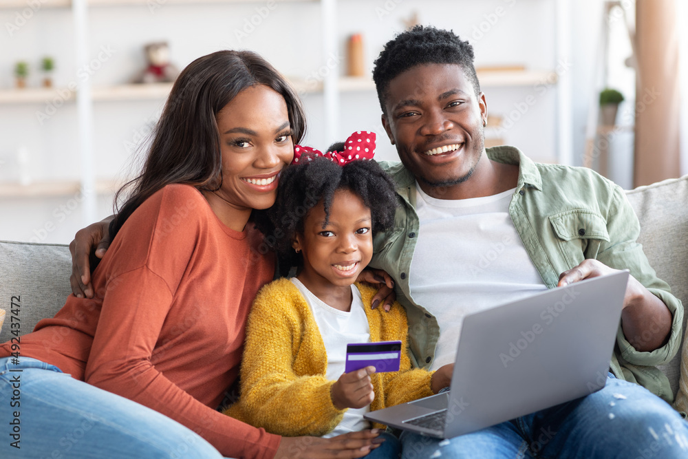 Happy Black Family With Laptop And Credit Card Relaxing At Home Happy Black Family With Laptop And Credit Card Relaxing At Home