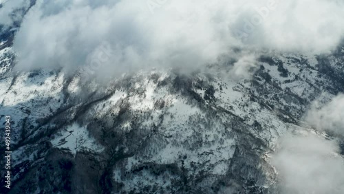 Drone shooting of Rocche del Crasto in winter, a mountainous and rocky complex where the golden eagle nests, Nebrodi, Sicily, Italy. Typical villages set between the fortresses. Longi and Alcara. photo