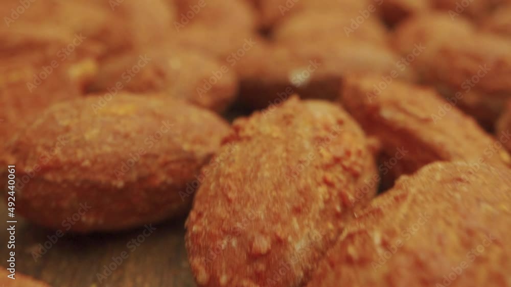 Nuts in sauce close-up. delicious fried kibbe on wooden table, top view. nuts background above closeup Nuts in sauce close-up. delicious fried kibbe on wooden table, top view. nuts background above closeup