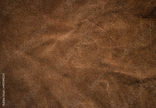 Photo of brown skin texture. Natural brown soft fabric. Brown background for text. Textured volumetric background made of soft fabric.