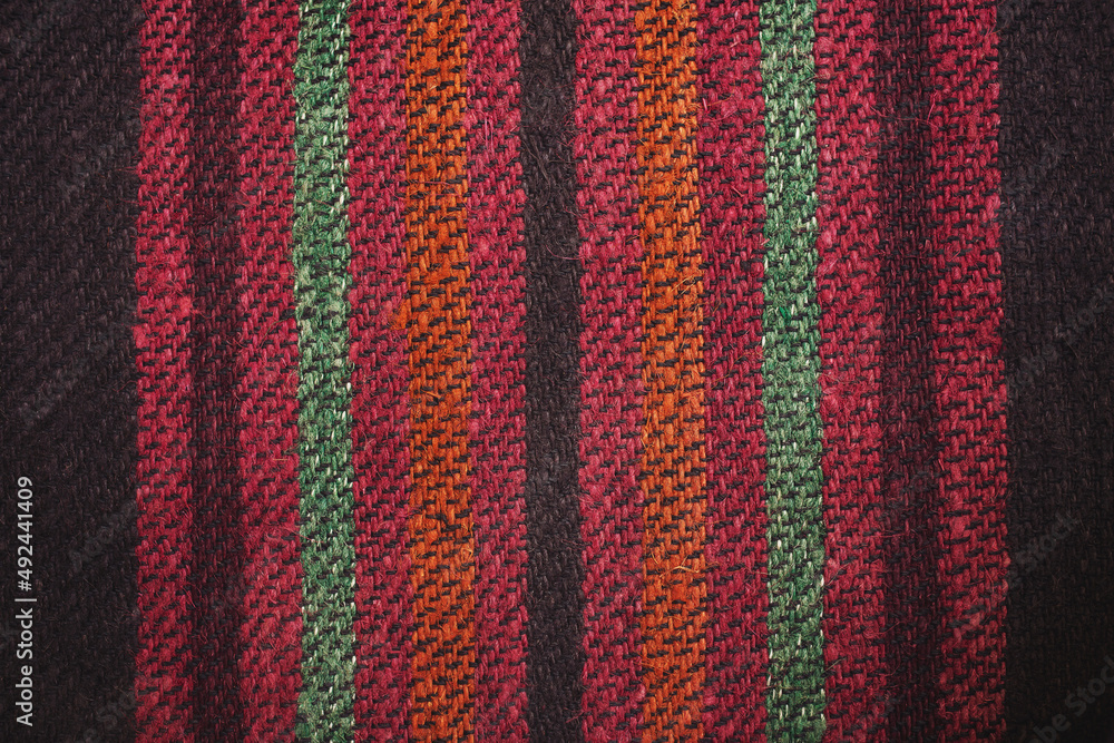 Close up of beautiful colorful hand made motley rug or carpet. Woven surface from interwoven thread of different colors, carpet fragment, seamless texture. Close up of beautiful colorful hand made motley rug or carpet. Woven surface from interwoven thread of different colors, carpet fragment, seamless texture.