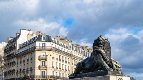 Paris, France, beautiful lion place Denfert-Rochereau in the 14e arrondissement, with typical buildings
 photo