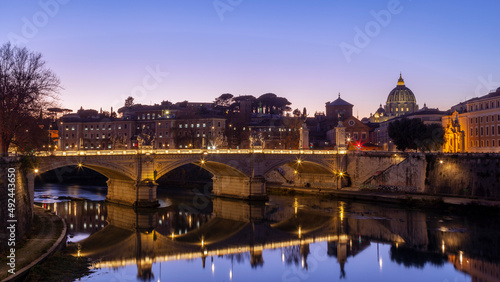Bridge of Vittorio Emanuele II over river Tiber, and the dome of Saint Peter's Basilica at the background, in the beautiful city of Rome, Italy, Europe. 