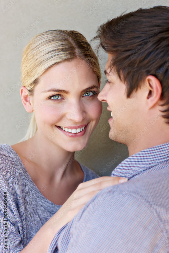 In love with life. Portrait of an affectionate young couple standing against a gray background. In love with life. Portrait of an affectionate young couple standing against a gray background.