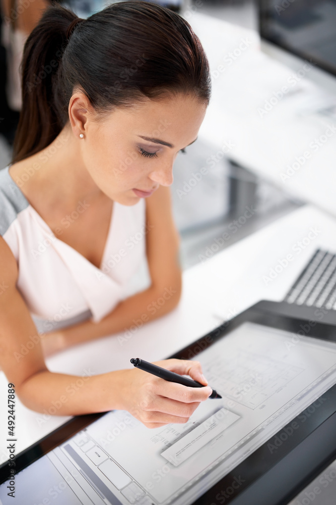 Design perfect. A young woman working on a digital touchscreen. Design perfect. A young woman working on a digital touchscreen.
