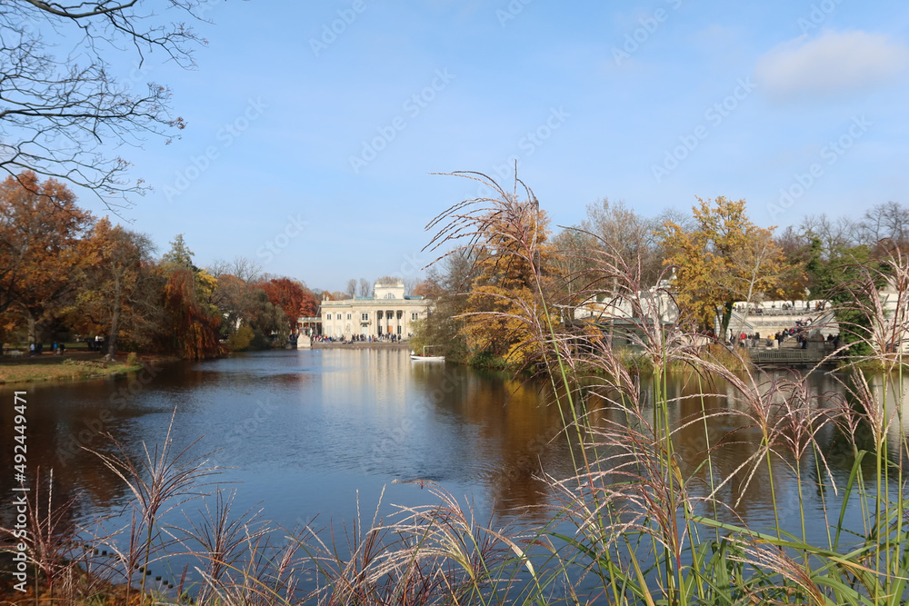 Autumn, fall time in Warsaw's Royal Baths Park. Warsaw, Poland.  Palace on the Water (or Lazienki Palace, Palace on the Isle). View from the side of the pond.
