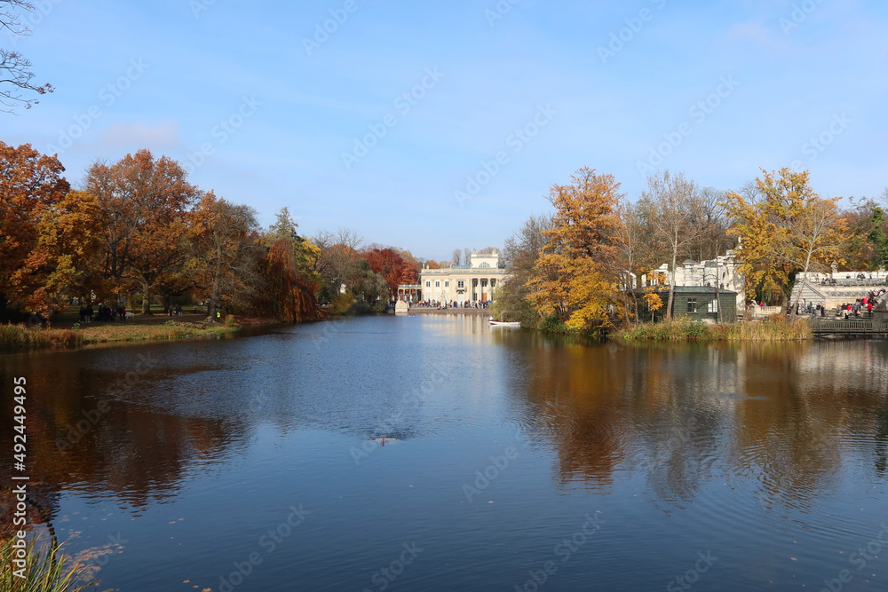 Autumn, fall time in Warsaw's Royal Baths Park. Warsaw, Poland.  Palace on the Water (or Lazienki Palace, Palace on the Isle). View from the side of the pond.