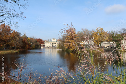 Autumn, fall time in Warsaw's Royal Baths Park. Warsaw, Poland. Palace on the Water (or Lazienki Palace, Palace on the Isle). View from the side of the pond.