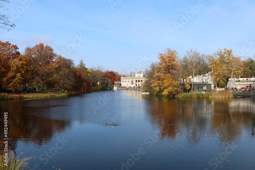 Autumn, fall time in Warsaw's Royal Baths Park. Warsaw, Poland. Palace on the Water (or Lazienki Palace, Palace on the Isle). View from the side of the pond.