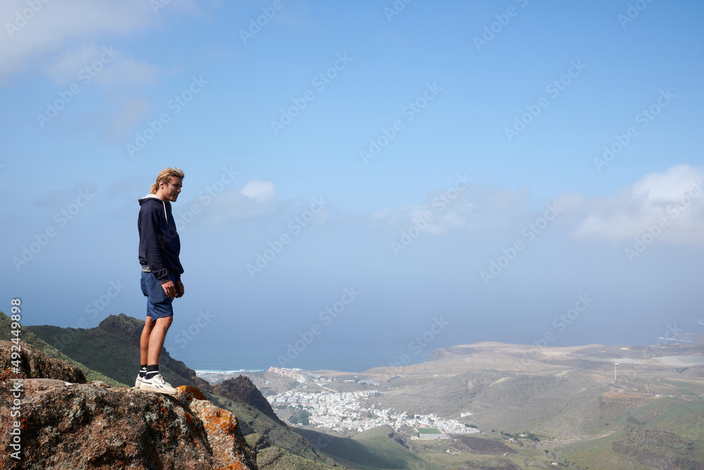 Obraz premium A young man admiring the beautiful views in the mountains in Gran Canaria