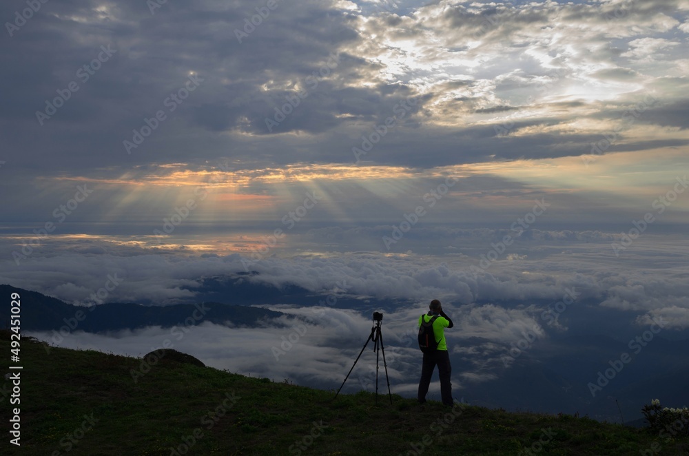 Blue sky. Cloud Sea. Photographer reminiscent of a fairy tale hero above the clouds. Blue sky. Cloud Sea. Photographer reminiscent of a fairy tale hero above the clouds.