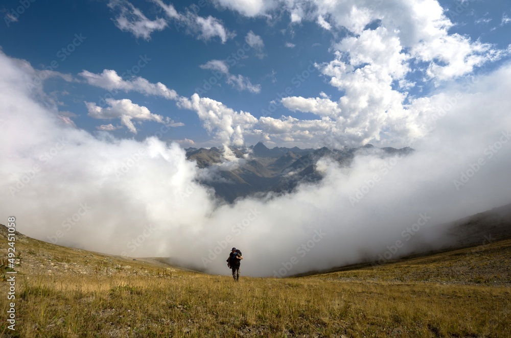Blue sky. Cloud Sea. Photographer reminiscent of a fairy tale hero above the clouds. Blue sky. Cloud Sea. Photographer reminiscent of a fairy tale hero above the clouds.