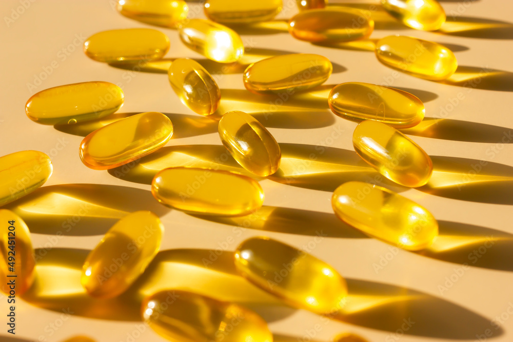 fish fat pills capsules vitamins omega 3 or hyaluronic acid are nutrients you get from food (or supplements) that helps build and maintain a healthy body. Dietary supplement. Macro, horizontal. fish fat pills capsules vitamins omega 3 or hyaluronic acid are nutrients you get from food (or supplements) that helps build and maintain a healthy body. Dietary supplement. Macro, horizontal.
