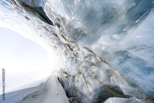 Breaking ice in glacier, ice wall texture taken from a natural glacier cave in Zinal, Switzerland 