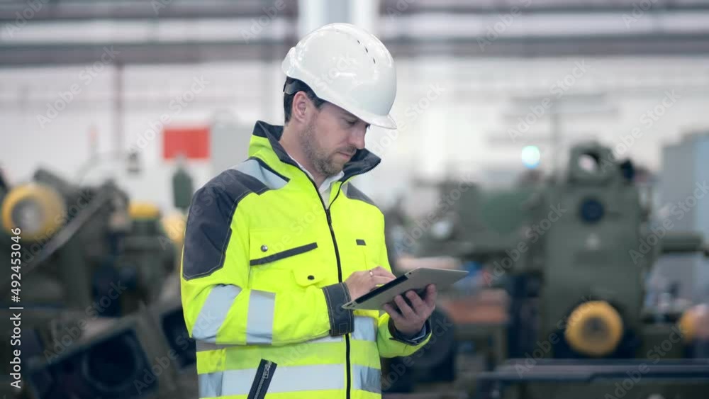 Engineer Is Using Tablet Pc In Factory. Slow-Motion.