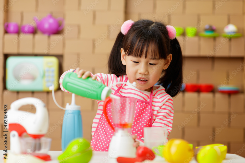 young girl pretend playing food preparing at home young girl pretend playing food preparing at home