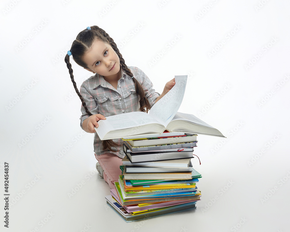 charming little girl turns the page of a big book charming little girl turns the page of a big book