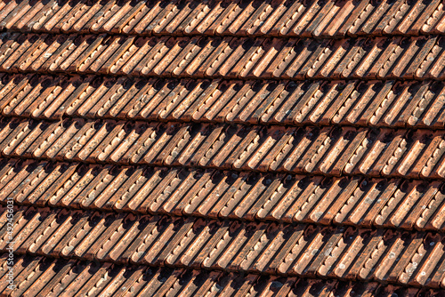 Red Roof tiles. Tile roof of a old house. Tile roofs used in old and modern style construction.