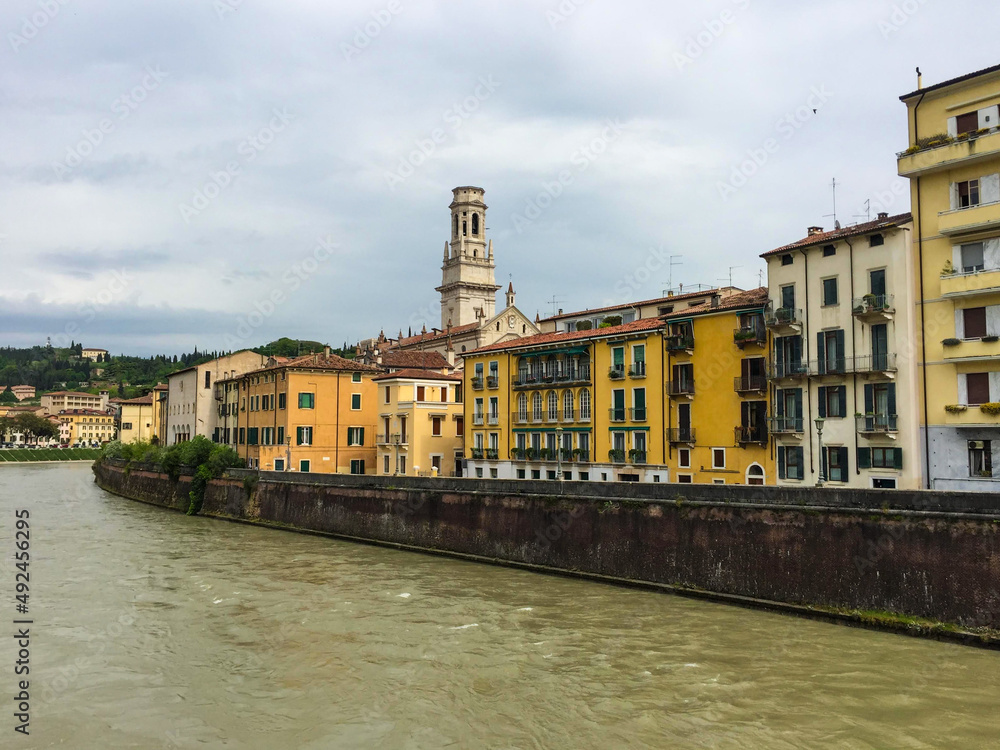 Verona, veneto, Italy. Trento. River Adige. Riverside and old terracotta buildings around.