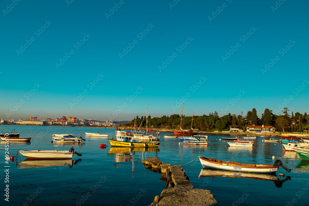 Old harbor with fishing boats in Tuzla. Blue sky and natural white clouds on day time. Small boats waiting for sail