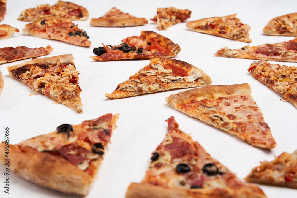 Pizza slices closeup isolated on white Pizza slices closeup isolated on white