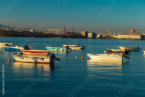 Old harbor with fishing boats in Tuzla. Blue sky and natural white clouds on day time. Small boats waiting for sail