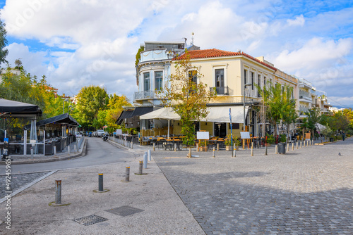 Fototapeta Naklejka Na Ścianę i Meble -  A Greek restaurant with outdoor sidewalk cafe patio near the Acropolis and Ancient Agora in the Monastiraki district of Athens, Greece.