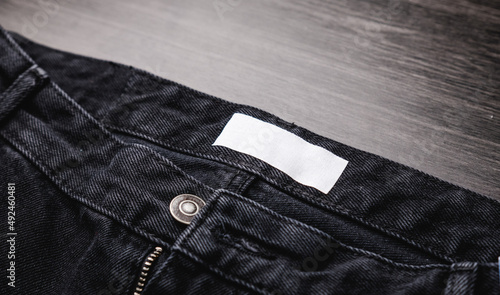 Blank clothing label on denim jeans texture. Label with empty space for text