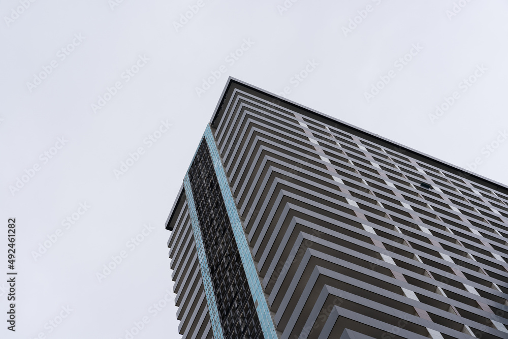 a very large apartment building that forms an interesting pattern and ornament, with a clear sky in the background a very large apartment building that forms an interesting pattern and ornament, with a clear sky in the background