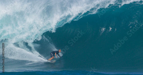 Surfer surfing big ocean barrel tube wave at Pipeline in north shore of Hawaii's Oahu island pro surfer Anthony Walsh photo