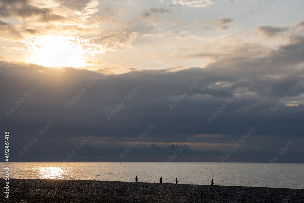 fabulously romantic sunset at sea with dark silhouettes of anglers on the horizon fabulously romantic sunset at sea with dark silhouettes of anglers on the horizon