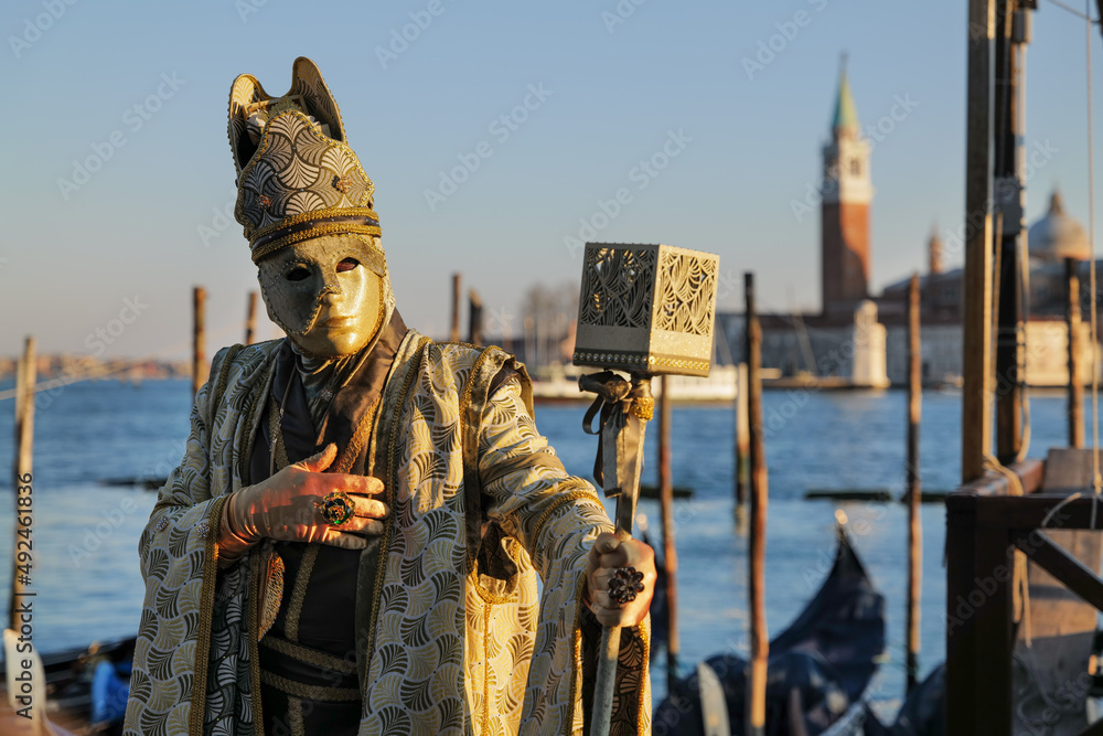 Fototapeta premium Venice, Italy - February 2022 - carnival masks are photographed with tourists in San Marco square