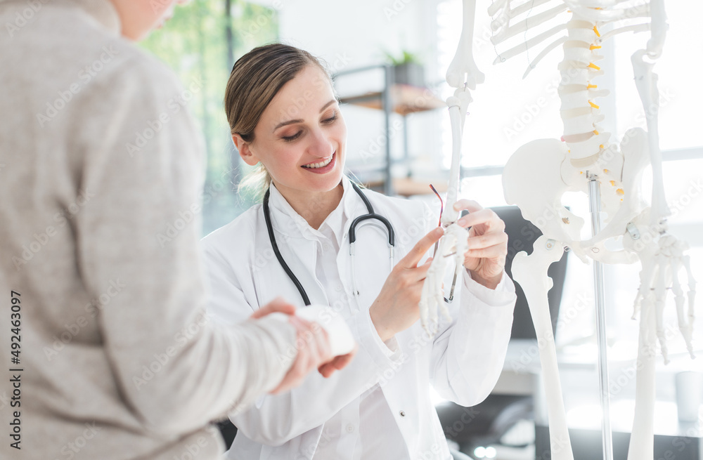 Doctor seeing boy with broken hand in her office Doctor seeing boy with broken hand in her office