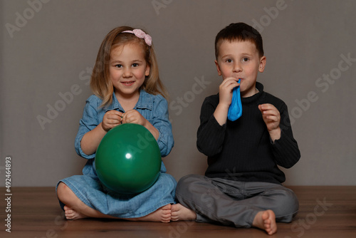 Kids are blowing balloons
