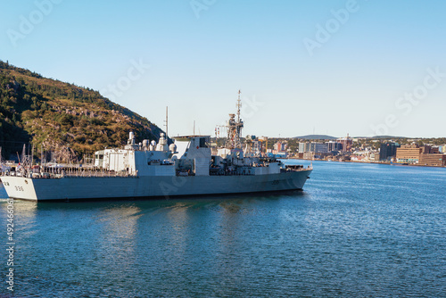 St. John's, Newfoundland, Canada-March 2022: The HMSC Montreal 336 frigate warship entering St. John's Harbour. The downtown shopping and business area of St. John's are in the background.